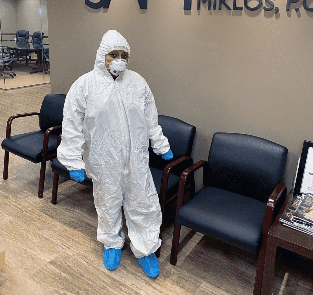 Construction cleaner wearing required protective cleaning equipment for construction cleaning