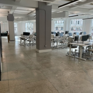 Cleaning concrete floor in office space in NYC office building.