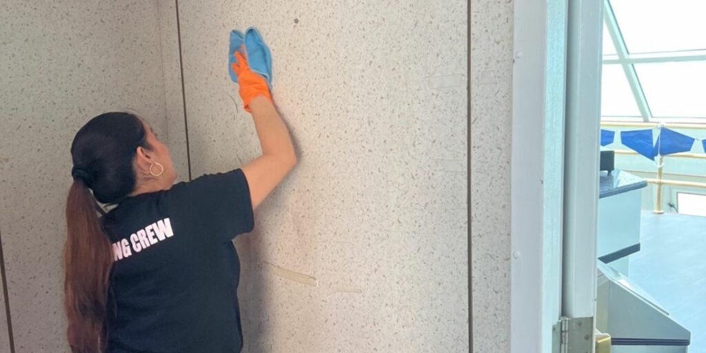 Construction cleaner cleaning off construction dust on wall
